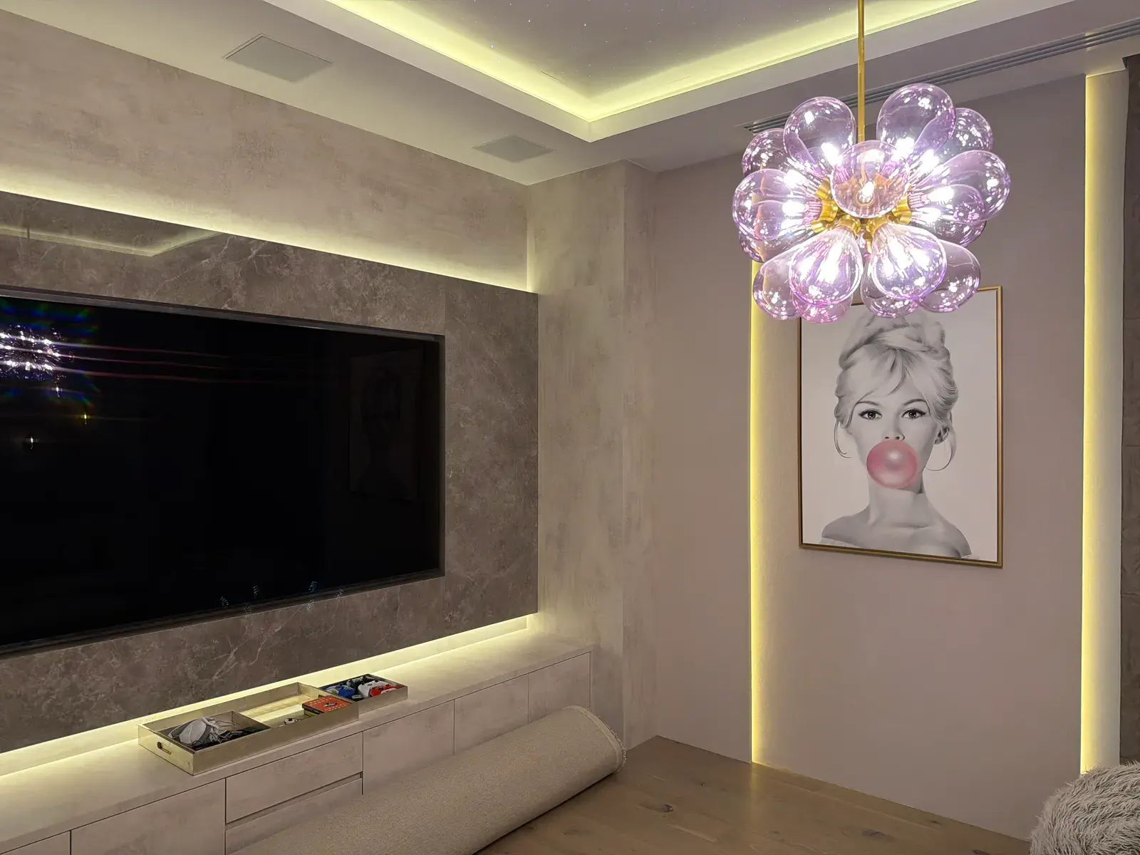 Marble media wall with a recessed television and concealed lighting