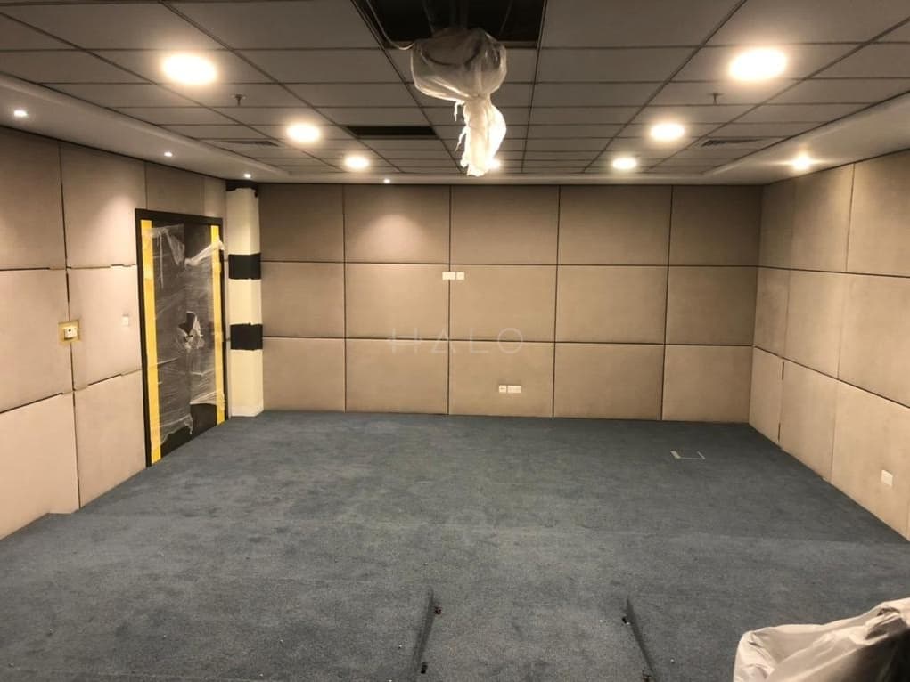 Completed flat gypsum ceiling with recessed downlights and panelled walls handed over ready for occupation