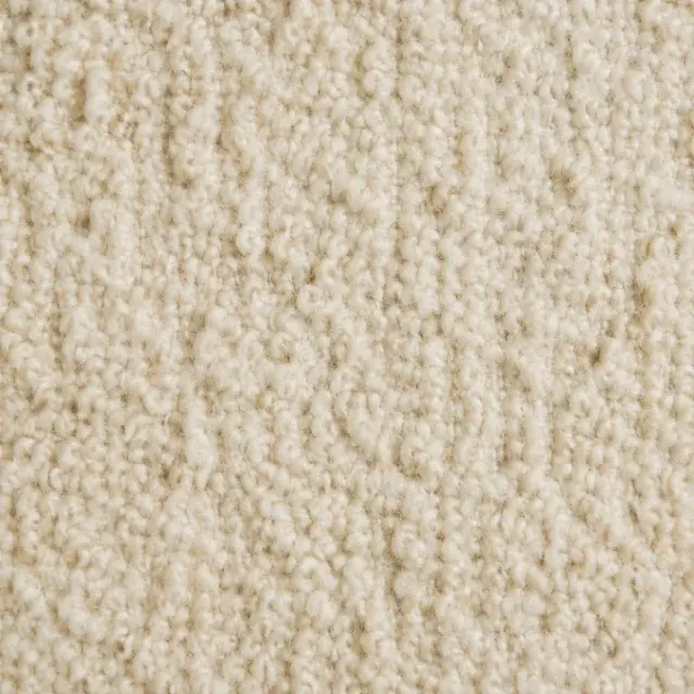 Close detail of tactile ivory boucle upholstery loops