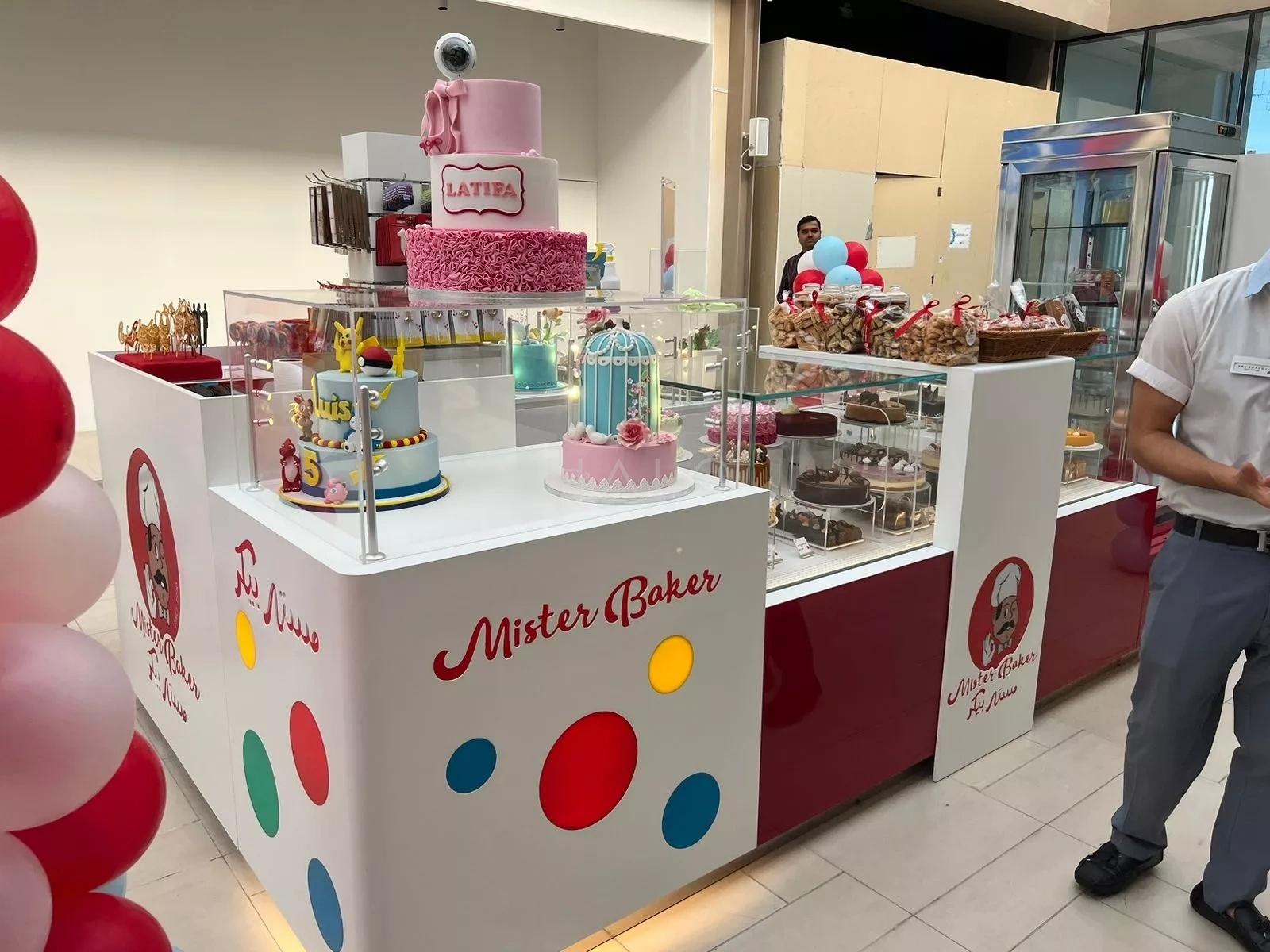 Branded cake and dessert kiosk with glazed display cabinets trading in a Dubai shopping mall