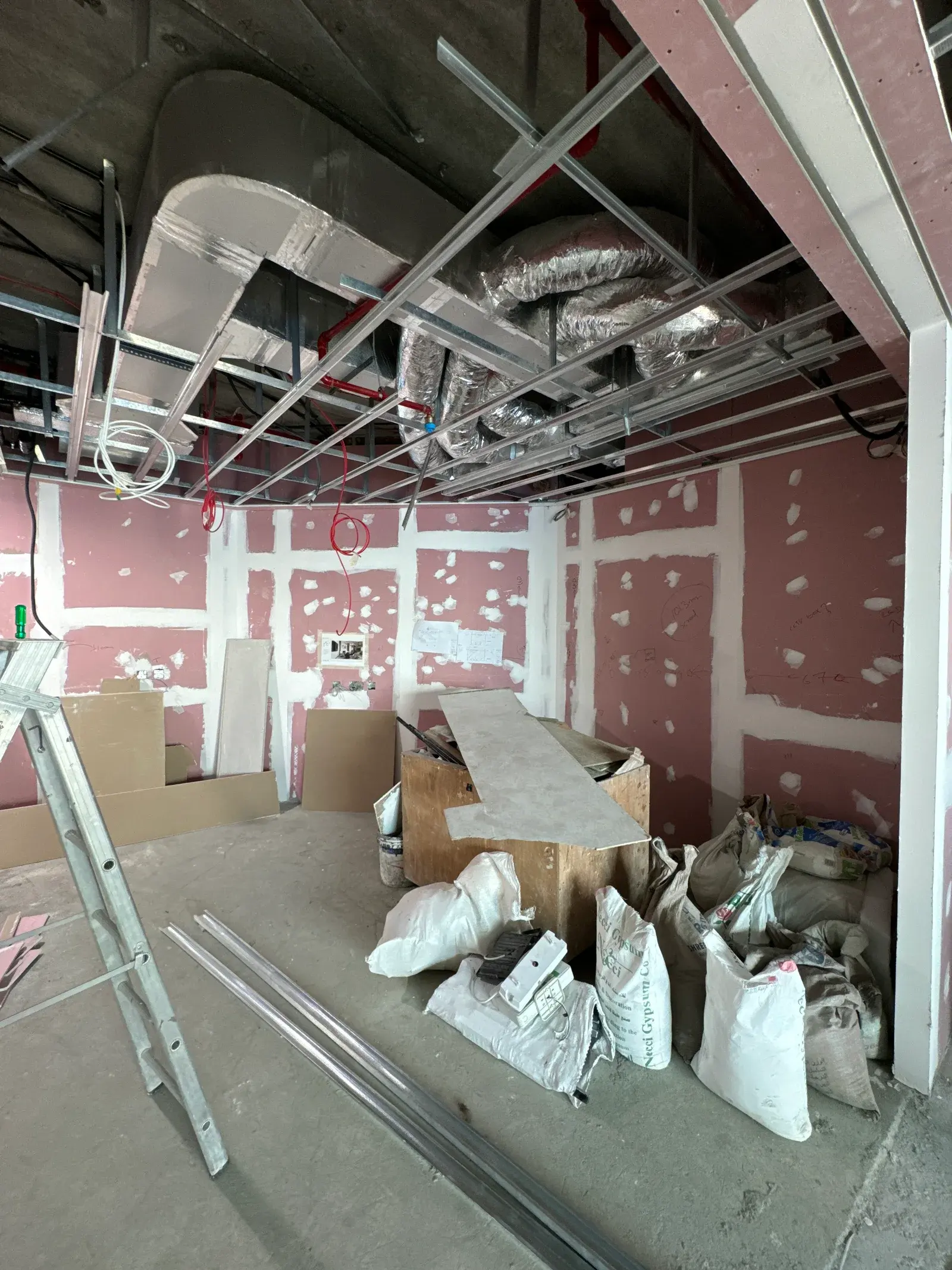 Rigid galvanised ductwork with flexible duct drops installed in an open soffit in Dubai