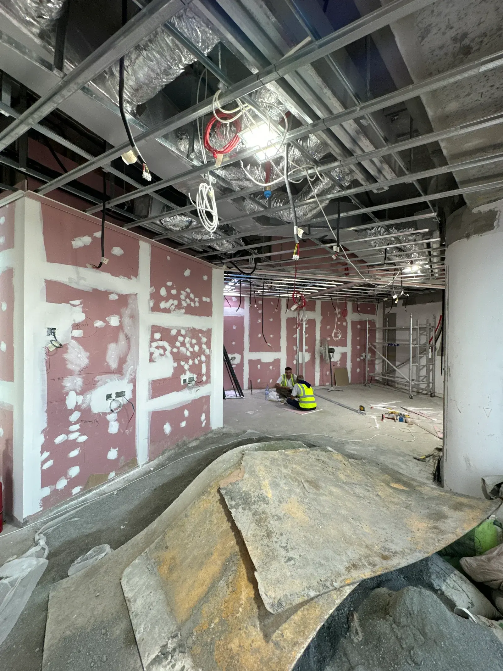 Flexible duct and diffuser drops above a ceiling grid during an air conditioning installation in Dubai