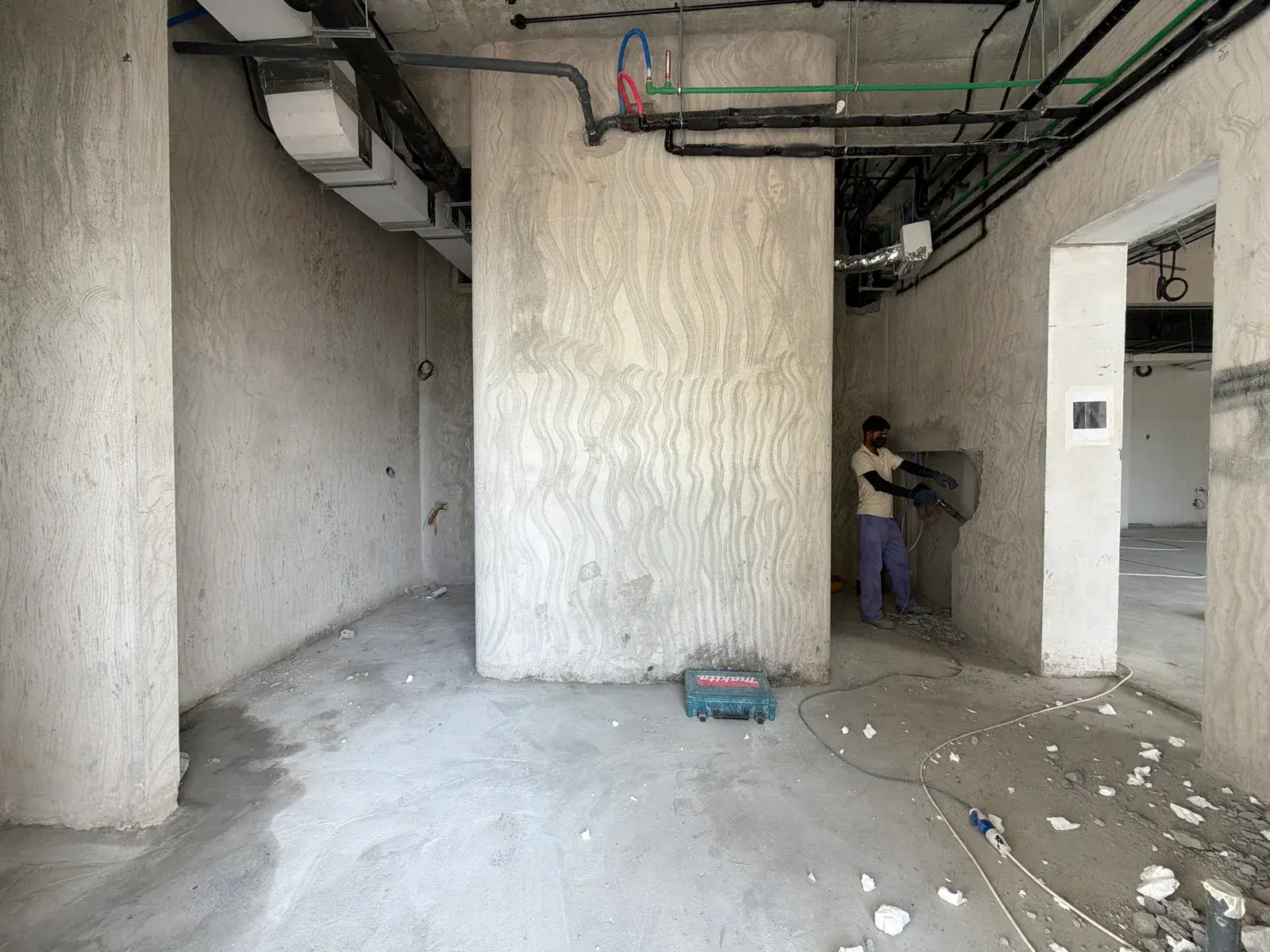 Pipework and services routed at a riser position on a soffit in a Dubai commercial unit