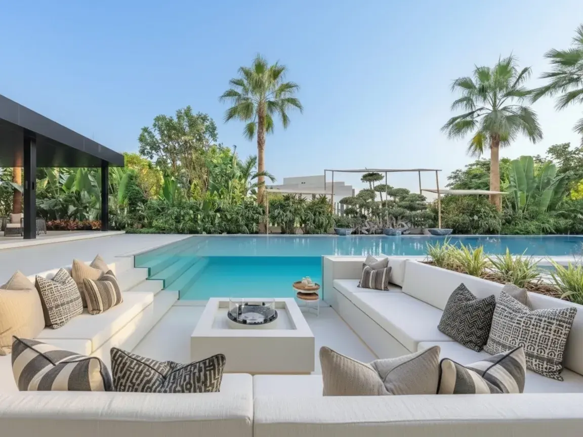 Sunken outdoor seating with striped cushions, a fire feature and palms