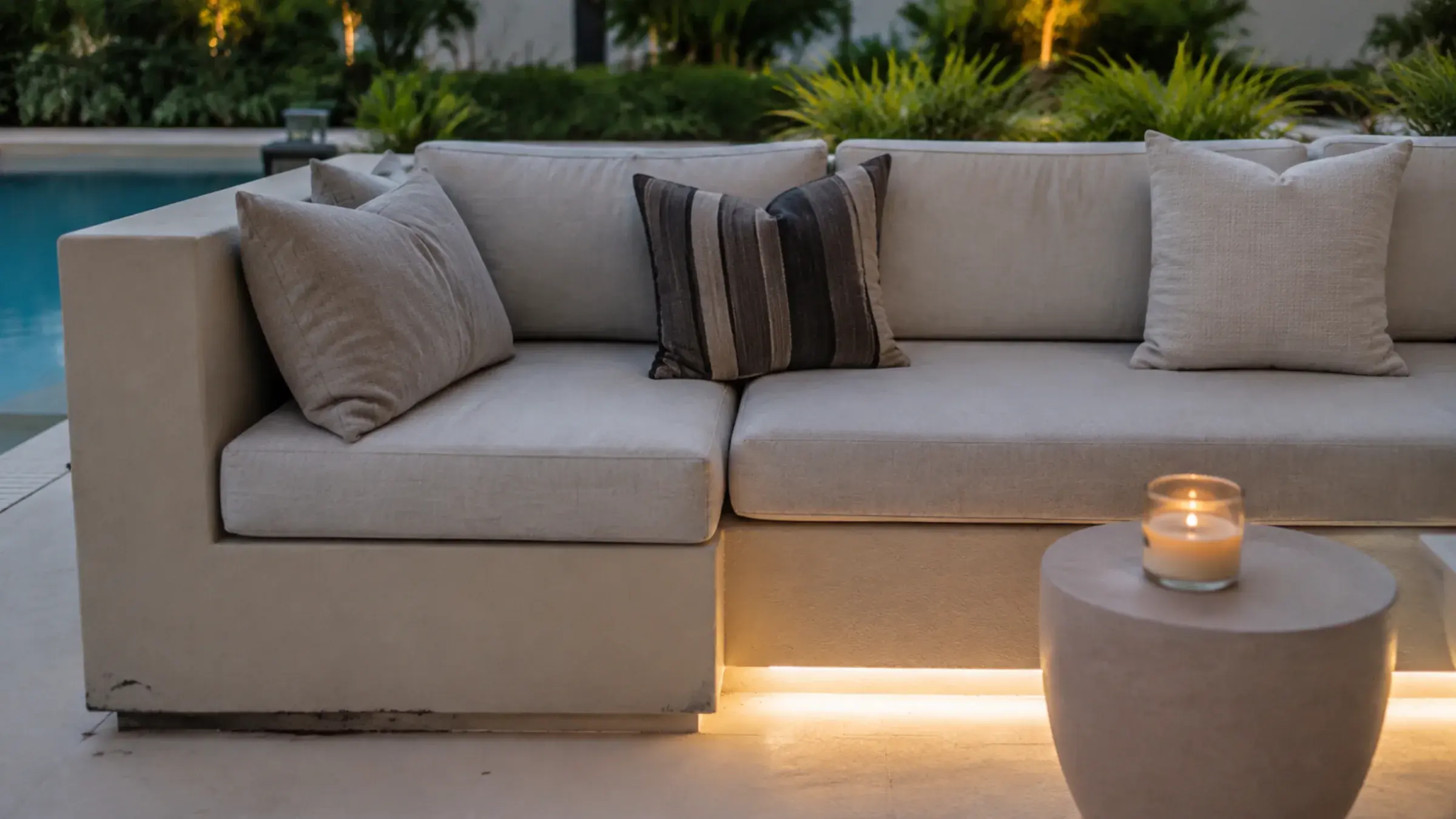 Shaded outdoor seating area with timber-toned cabinetry and soft textiles
