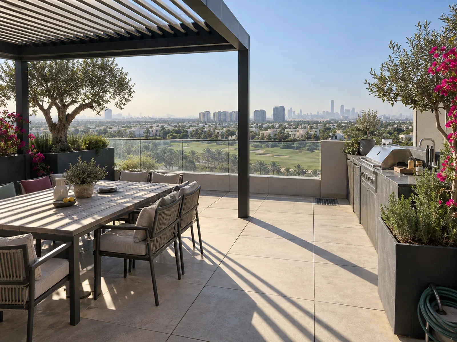 Penthouse roof terrace with pedestal paving, aluminium planters and a louvred pergola over Dubai Hills
