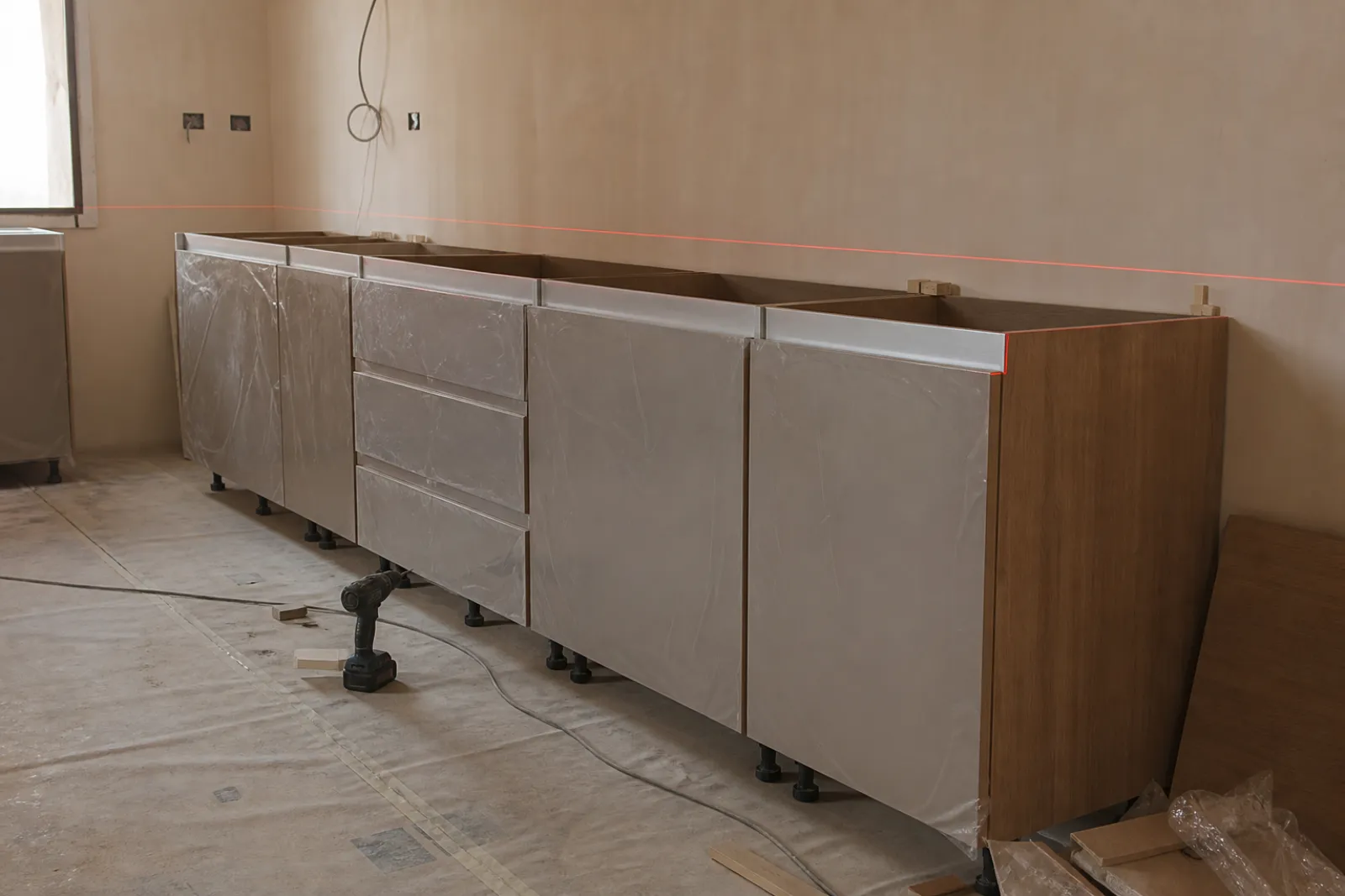 Kitchen carcasses levelled and scribed on site before worktop templating